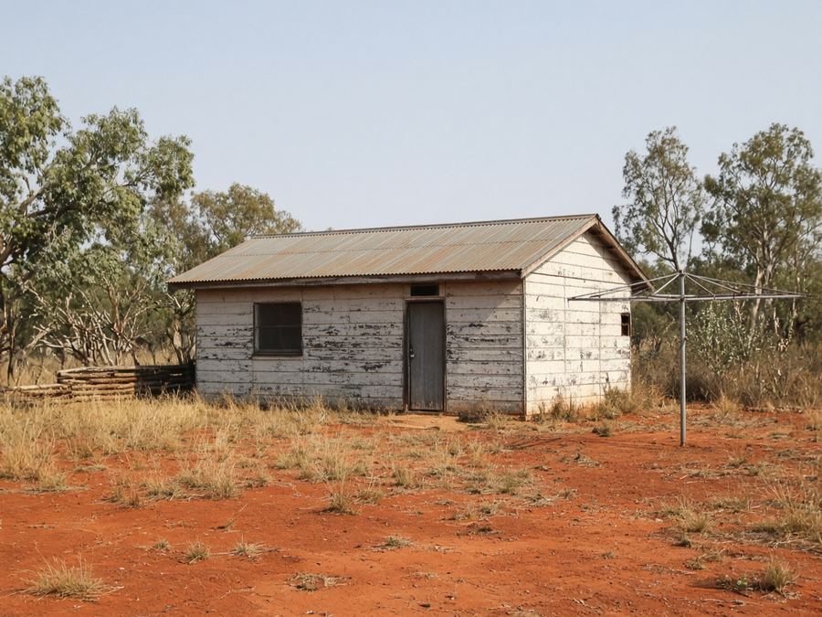 Old fibro cottage with a Hills Hoist in the backyard